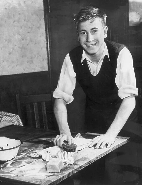 Englands Bobby Charlton aged 15, helping his mother with the housework at home, 1953