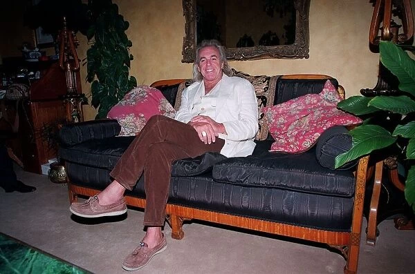 English nightclub owner Peter Stringfellow at home relaxing. September 1998