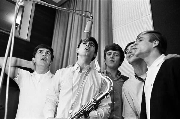 The English pop rock group, Dave Clark Five singing in a recording studio