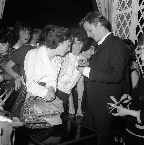 English singer Mike Sarne signing autographs for female fans. 12th September 1962
