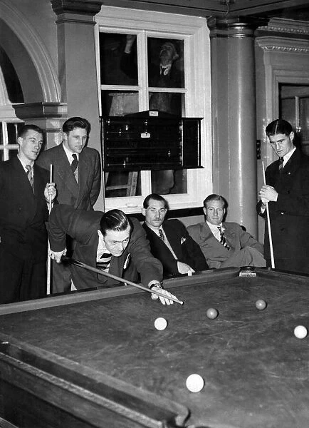 Some of the English team playing billiards does not seem to notice the decorator Mr