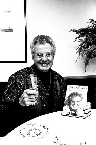 Entertainer Danny La Rue at a Newcastle restaurant signing copies of his autobiography