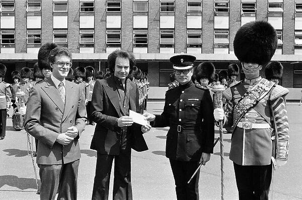 Entertainer Neil Diamond and Lord Tavistock present a cheque to the 2nd Battalion