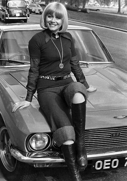 Entertainment actress Anne Aston sitting on the bonnet of her car. May 1976 P017209