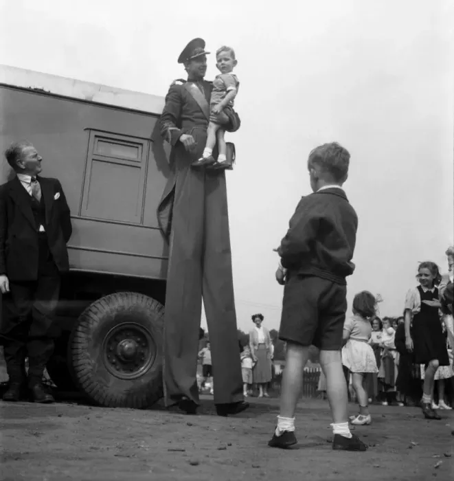 Framed Print : Entertainment : Circus Stilt Walker With Young Child. D3364 Framed Print : Entertainment : Circus Stilt Walker With Young Child. D3364