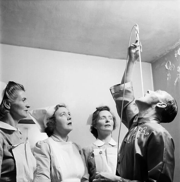 Entertainment : Sword Swallowing. Maurice Jarvis, 35, Demonstrates to the amazed nurses