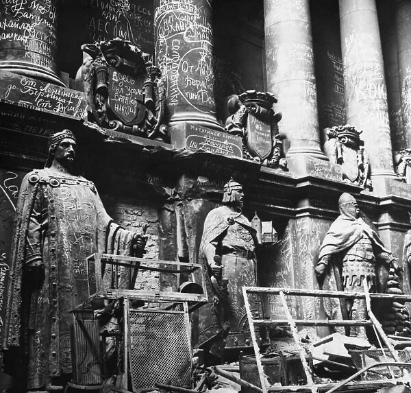 Entrance to the Reichstag building showing Russian graffiti on statues of prominent