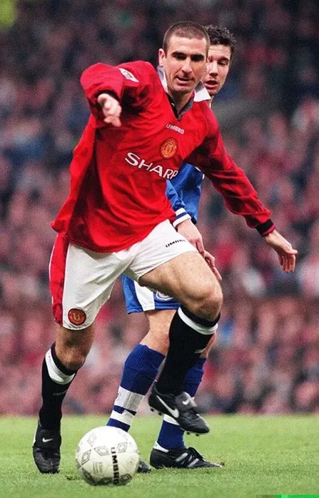 Framed Print : Eric Cantona fends off a Leicester defender during their match at Old Trafford Framed Print : Eric Cantona fends off a Leicester defender during their match at Old Trafford
