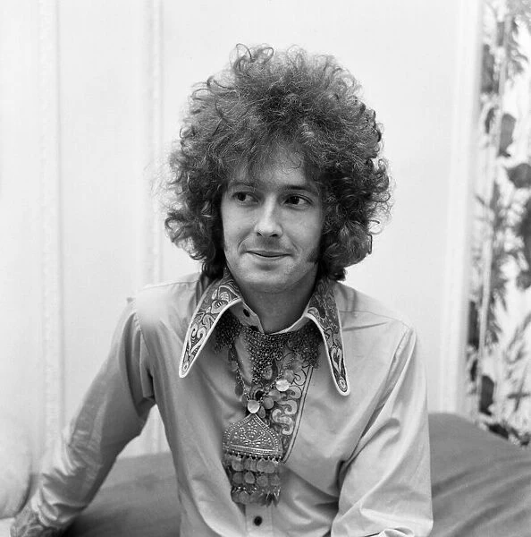 Eric Clapton of Cream shows off his curly hair that is created for him by a West End