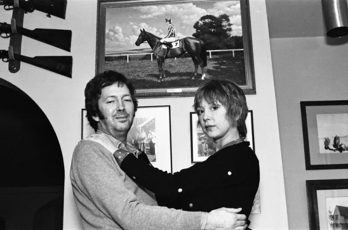 Framed Print : Eric Clapton and wife Pattie, pictured in front of a photograph of his racehorse Via