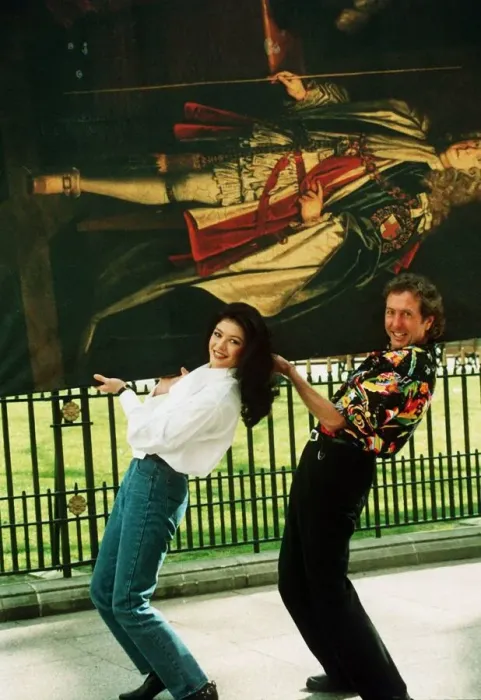 Framed Print : Eric Idle and Catherine Zeta Jones carrying painting 1993
