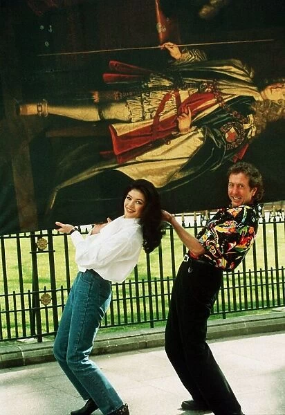 Eric Idle and Catherine Zeta Jones carrying painting 1993