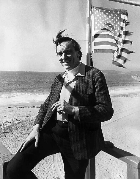 Eric Porter British actor standing on a beach under the American Flag