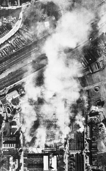 The Erla Aircraft factory in Antwerp burning after a U. S. A. A. F