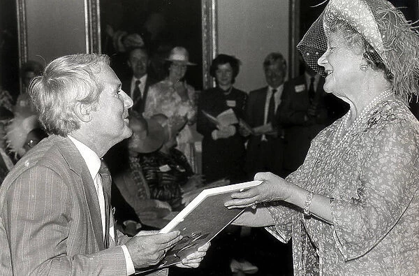 ERNIE WISE RECIEVES A COMMENDATION FROM THE QUEEN MOTHER FOR HIS WORK IN THE