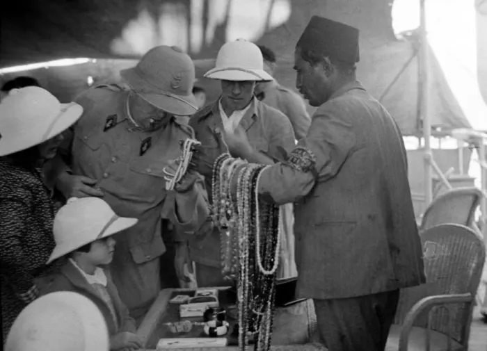 Framed Print : European looking at beads and jewellery for sale in a shop in Somaliland Circa 1935 Framed Print : European looking at beads and jewellery for sale in a shop in Somaliland Circa 1935