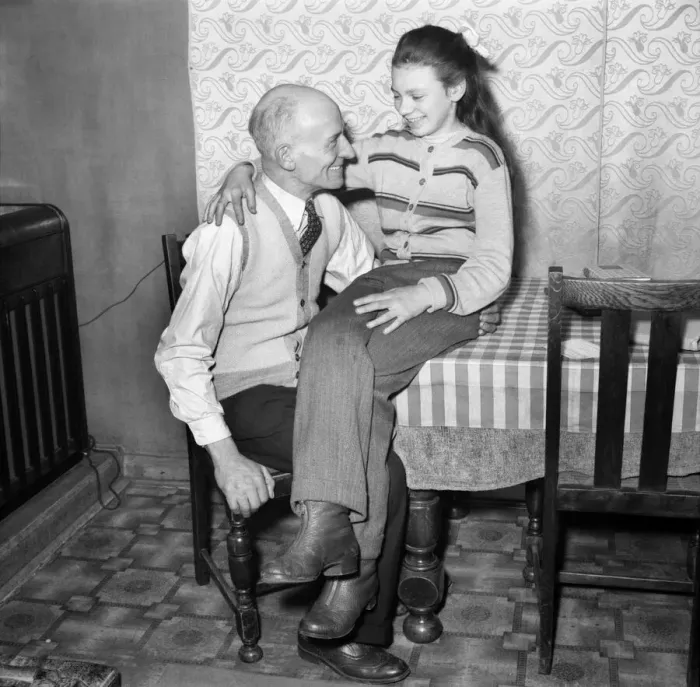 Framed Print : Eva Spiers with her father in her home still wearing the slacks that caused her to be Framed Print : Eva Spiers with her father in her home still wearing the slacks that caused her to be