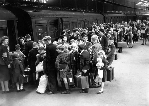 Evacuation scenes at Euston Station, London, boarding a train to Lancashire. July 1944