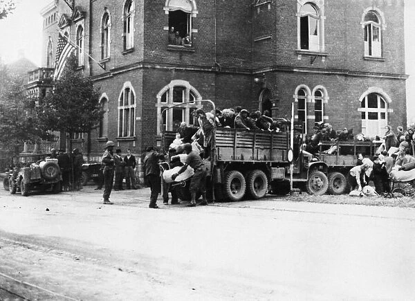 Evacuees are brought into the town of Brand, Germany, where they were registered