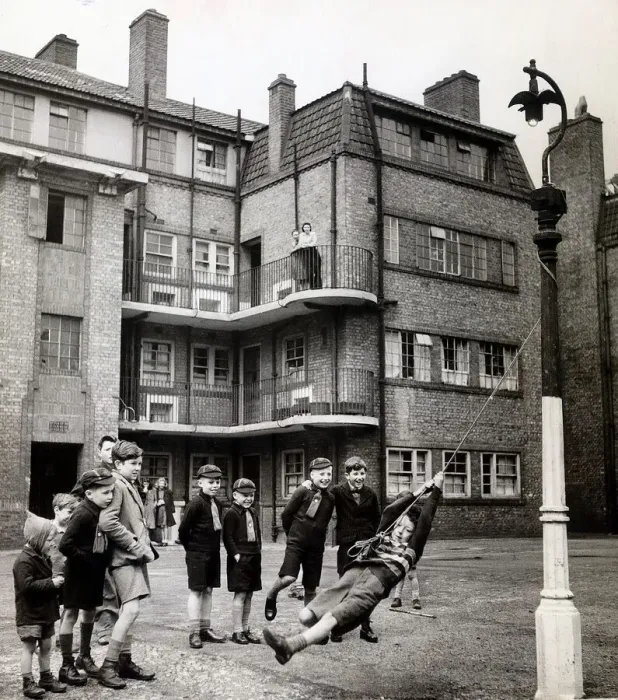 Framed Print : Evacuees returning from Leicestershire play in the street outside their tenement block in Framed Print : Evacuees returning from Leicestershire play in the street outside their tenement block in