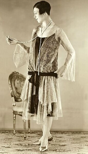 Eveningwear circa 1925. Woman modelling the trends of 1926