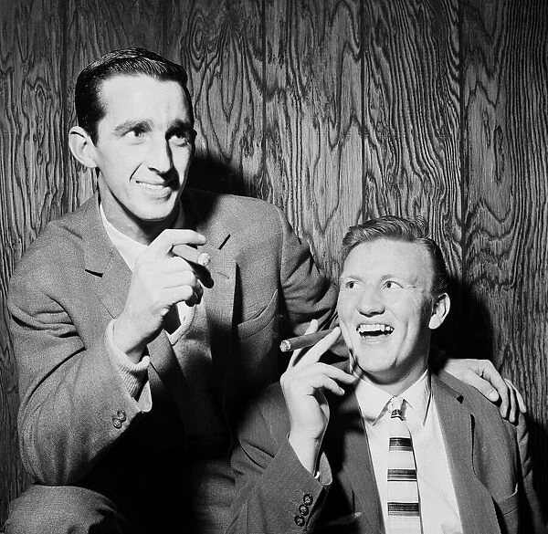 Everton football players Roy Vernon and Jimmy Gabriel smoking cigars as they celebrate