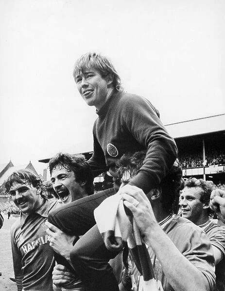 Everton footballer Adrian Heath sits on the shouders of jubilant teammates Derek