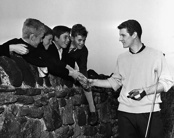 Everton footballer Brian Labone with schoolboy admirers after a round of golf at Bootle