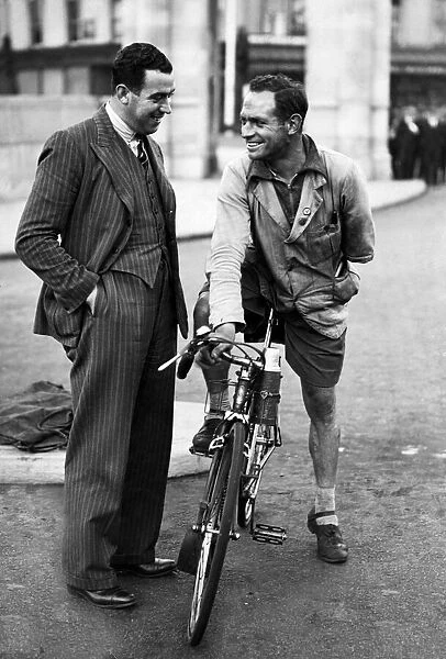 Everton footballer Dixie Dean talking with a cyclist in Liverpool. Circa 1936