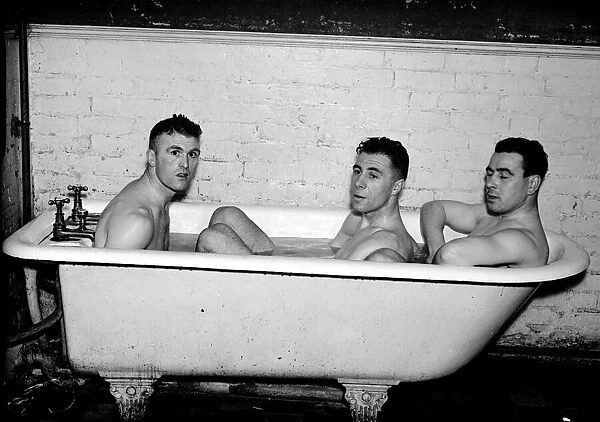 Everton footballers (left-right) JN Cunliffe, C Button and W Cook in the bath after