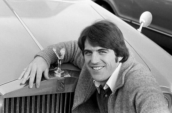 Everton forward Bob Latchford posing beside a Rolls Royce