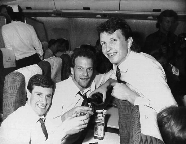 Everton goalscorers Kevin Sheedy, Andy Gray and Trevor Steven celebrate on the plane home