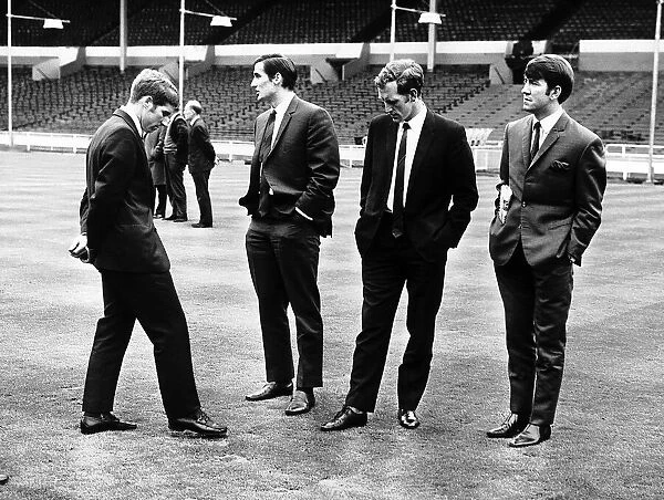 Everton midfielders Alan Ball and Howard Kendall inspect the Wembley pitch with teammates