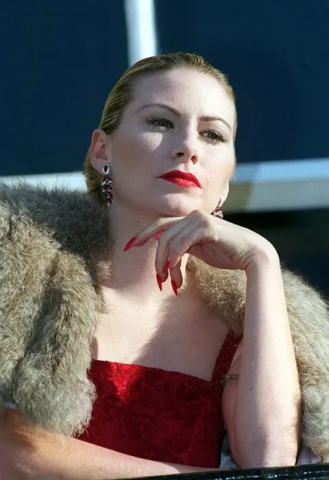 Framed Print : Evita Fashion Model on balcony wearing fur cape red dress long nails with red nail Framed Print : Evita Fashion Model on balcony wearing fur cape red dress long nails with red nail