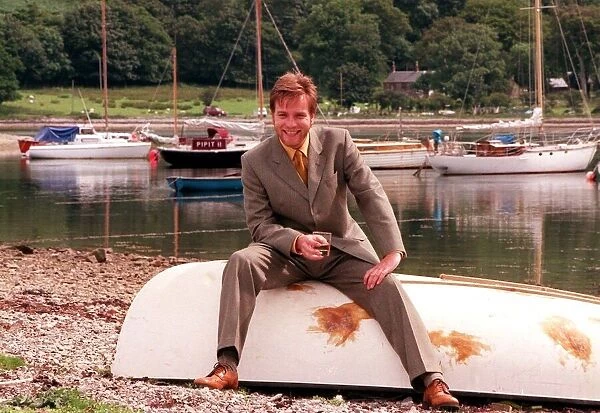 Ewan McGregor on the Isle of Arran July 1998 with glass of Loch Ranza whisky sitting