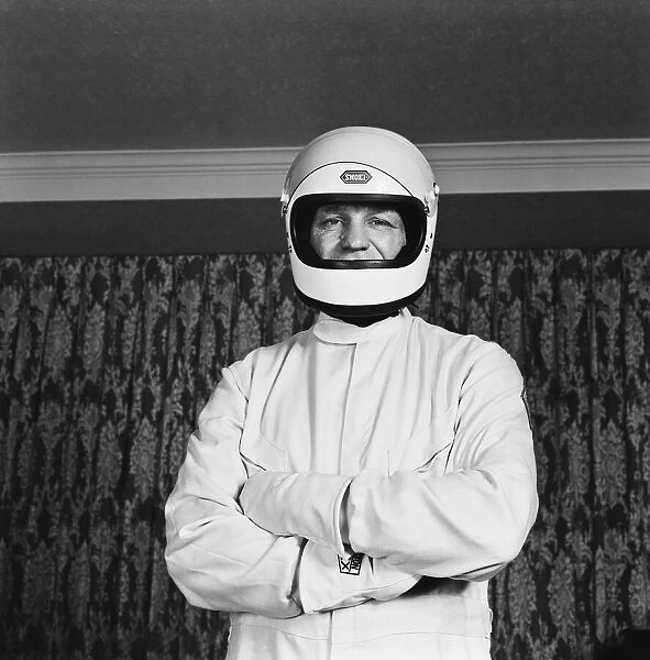 Ex Boxer Henry Cooper dressed in a Formula One out-fit. Formula One was one of his