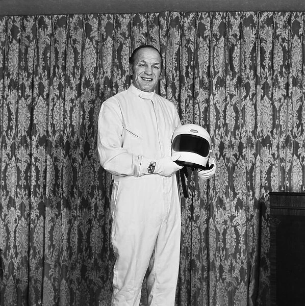 Ex Boxer Henry Cooper dressed in a Formula One out-fit. Formula One was one of his