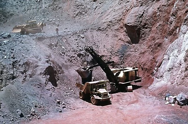 Excavator loads Iron-ore into lorry at Mine, Cassinga Angola