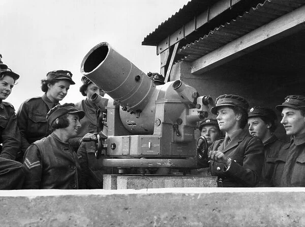 At an experimental gunnery camp in Manorbier, Wales, members of the Auxiliary Territorial