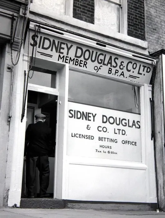 Framed Print : An exterior view of Sidney Douglas betting shop in Mile End Road London May 1961