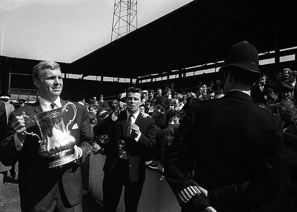 FA Cup 1964 Bobby Moore with the FA Cup walking around the Upton Park ground showing