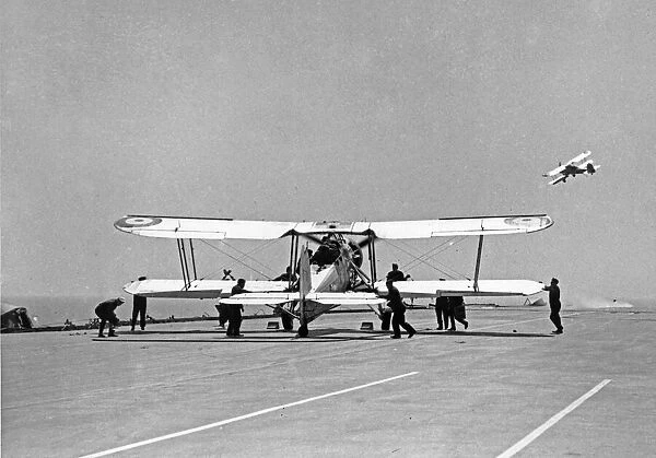 Fairey Swordfish planes launch from the flight deck of the Royal Navy Aircraft Carrier