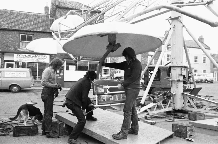 Framed Print : Fairground workers assembly a ride in Stokesley in preparation of the annual fair