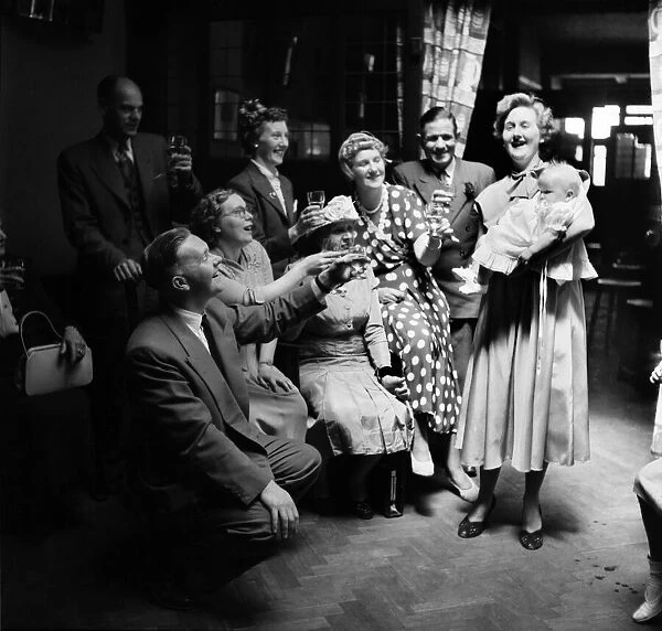 Families : Chirstening. The Irons family toast Lee after the Christening. July 1953 D3465