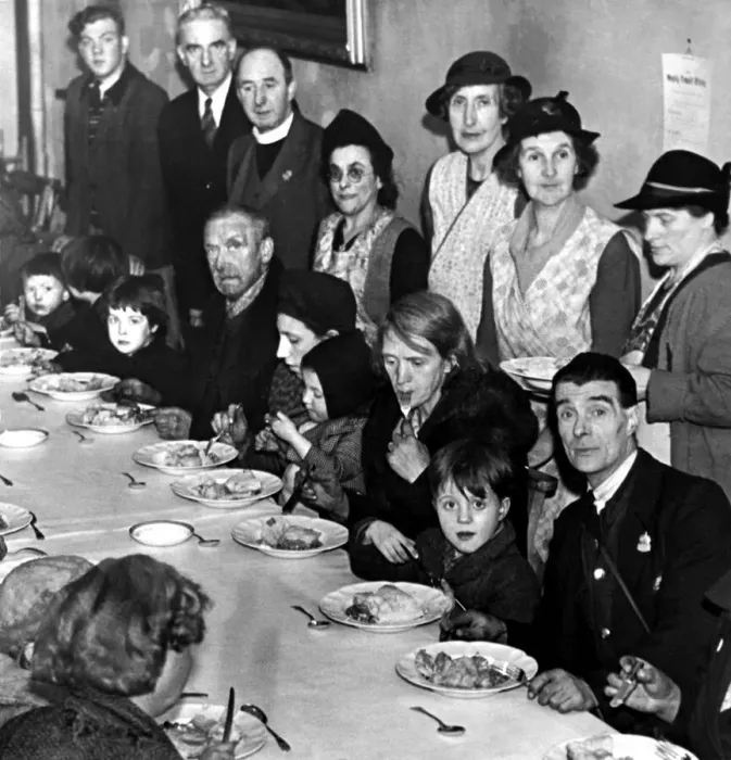 Framed Print : Families enjoy a hot meal at an emergency centre. They had been rendered homeless from a Framed Print : Families enjoy a hot meal at an emergency centre. They had been rendered homeless from a