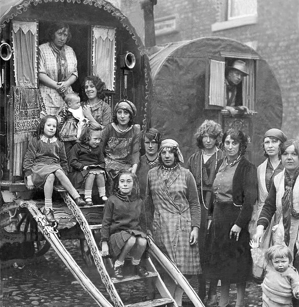 Families of gypsies outside their caravans at Yarm Fair in October 1931