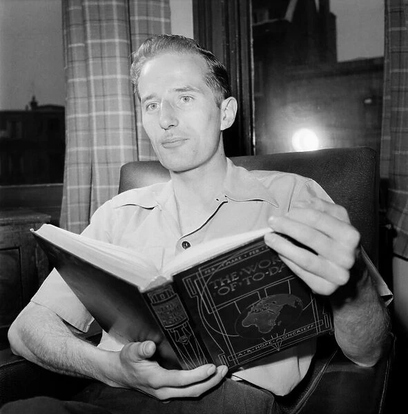 Families. Man Reading book. July 1953 D3424-001