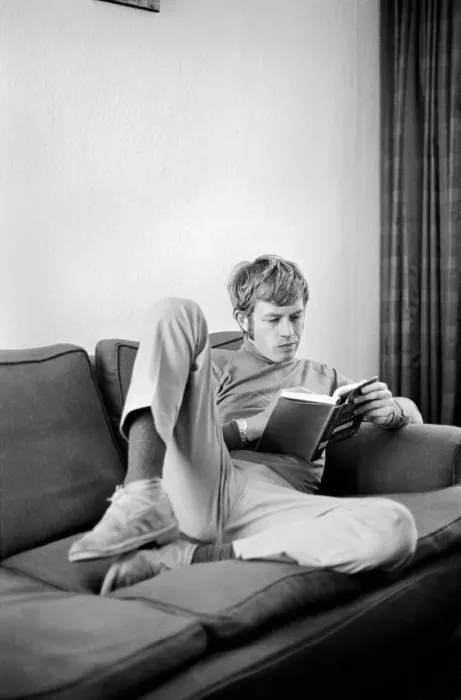 Framed Print : Families: Mother, father and children. Man relaxing at home, reading a book on his sofa Framed Print : Families: Mother, father and children. Man relaxing at home, reading a book on his sofa