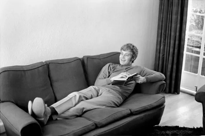 Framed Print : Families: Mother, father and childrens. Man relaxing at home, reading a book on his sofa Framed Print : Families: Mother, father and childrens. Man relaxing at home, reading a book on his sofa