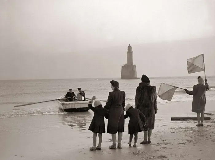 Framed Print : The families of the Rattray Head lighthouse keepers semaphore their loved ones as Old Framed Print : The families of the Rattray Head lighthouse keepers semaphore their loved ones as Old